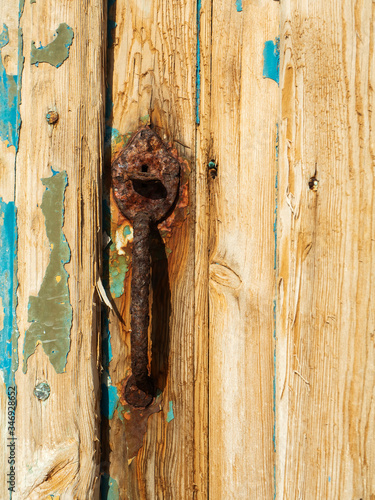 A Rust Door Lock and Cracked Paint at Klima Fishing Village - Milos Island, Greece photo