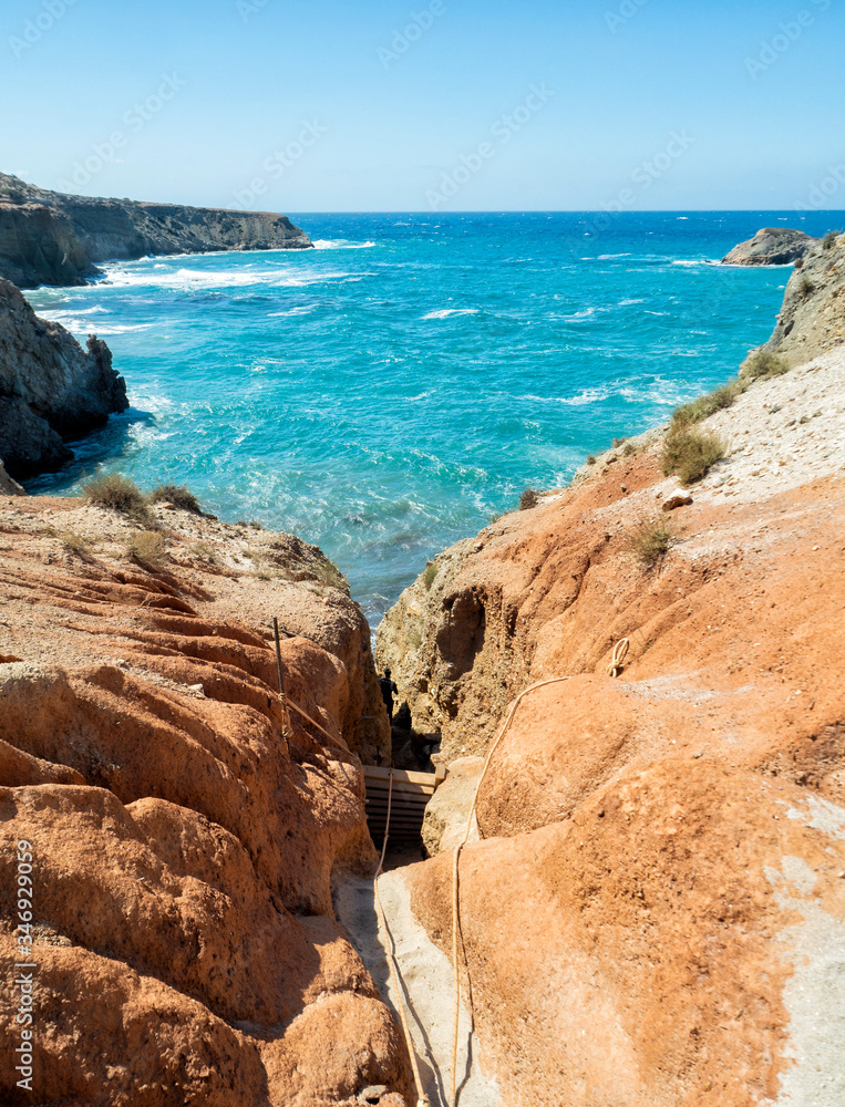 Ladder to climb down to Tsigrado Beach at Milos Island - Greece Ladder to climb down to Tsigrado Beach at Milos Island - Greece