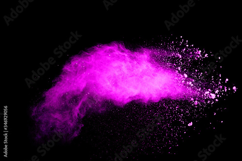 Pink powder explosion on black background. Halloween background.