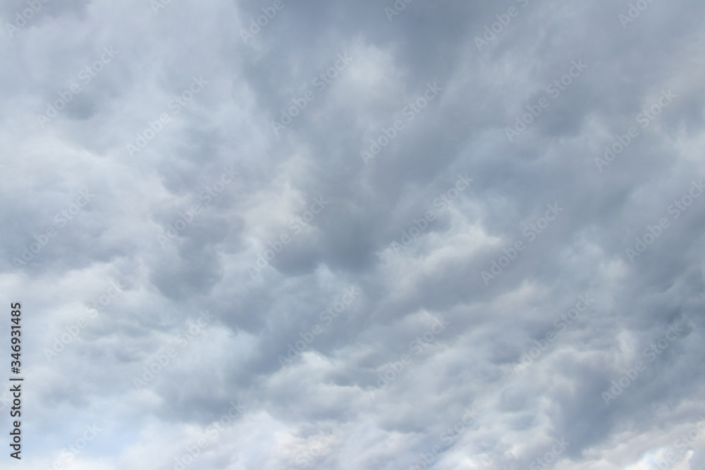 Thick gray clouds in the sky. The sky before the rain