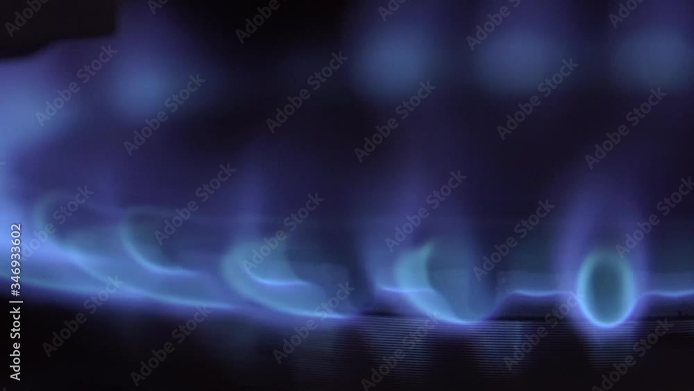 flame burns on a gas stove in the dark. Close-up Slow Motion Macro. flame burns on a gas stove in the dark. Close-up Slow Motion Macro.