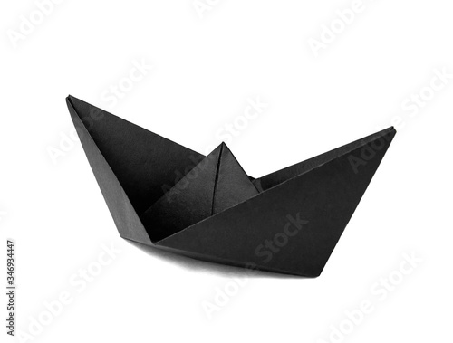 Origami black paper boat isolated on white background