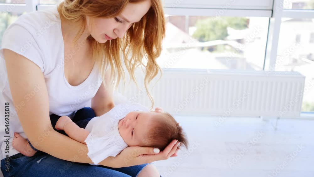 Mother smiling to her cute baby Mother smiling to her cute baby