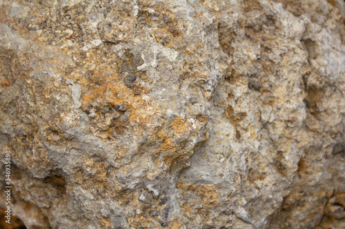 the surface of a yellow stone with a brown tint