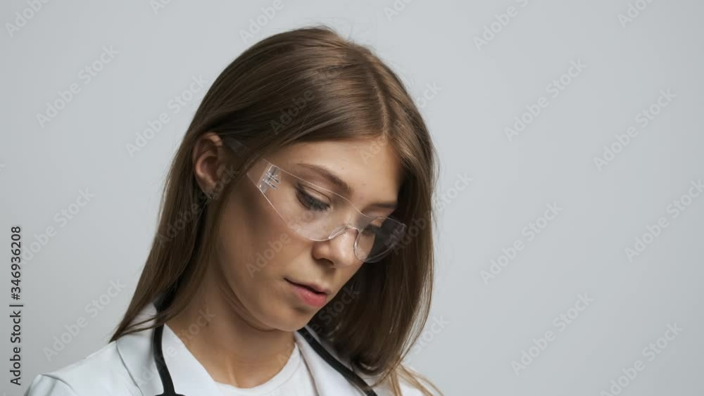 Women doctor of Caucasian appearance writes on paper a 4. Medicine. Health Women doctor of Caucasian appearance writes on paper a 4. Medicine. Health