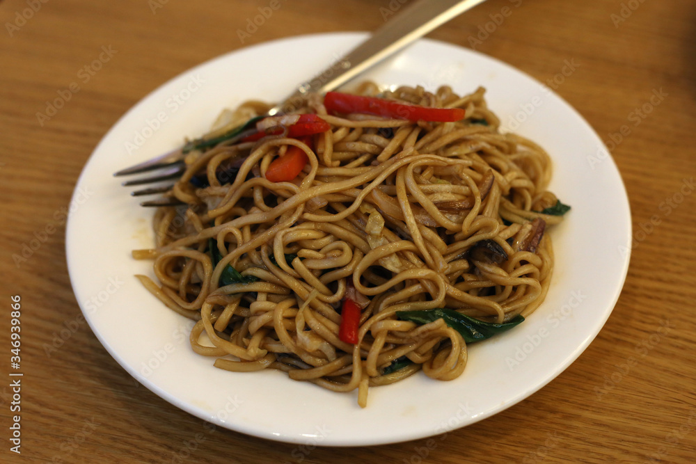 Fried noodles with vegetables served in Din Tai Fung restaurant of Mall of the Emirates in Dubai UAE, December 2019. Healthy, delicious and fresh asian food offering good value for money.