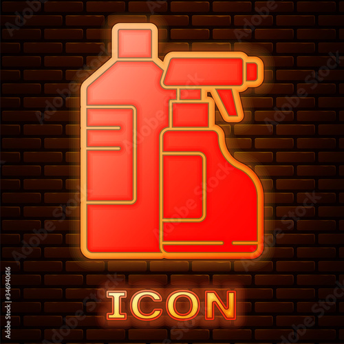 Glowing neon Plastic bottles for laundry detergent, bleach, dishwashing liquid or another cleaning agent icon isolated on brick wall background.  Vector Illustration