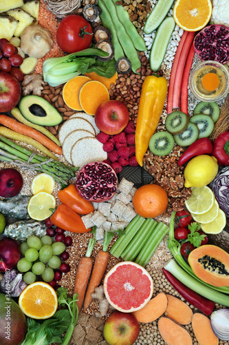 Fototapeta Naklejka Na Ścianę i Meble -  Large collection of immune boosting healthy food for fitness & energy with foods high in antioxidants, anthocyanins, vitamins, minerals, protein, omega 3, smart carbs, lycopene & fiber. Flat lay.