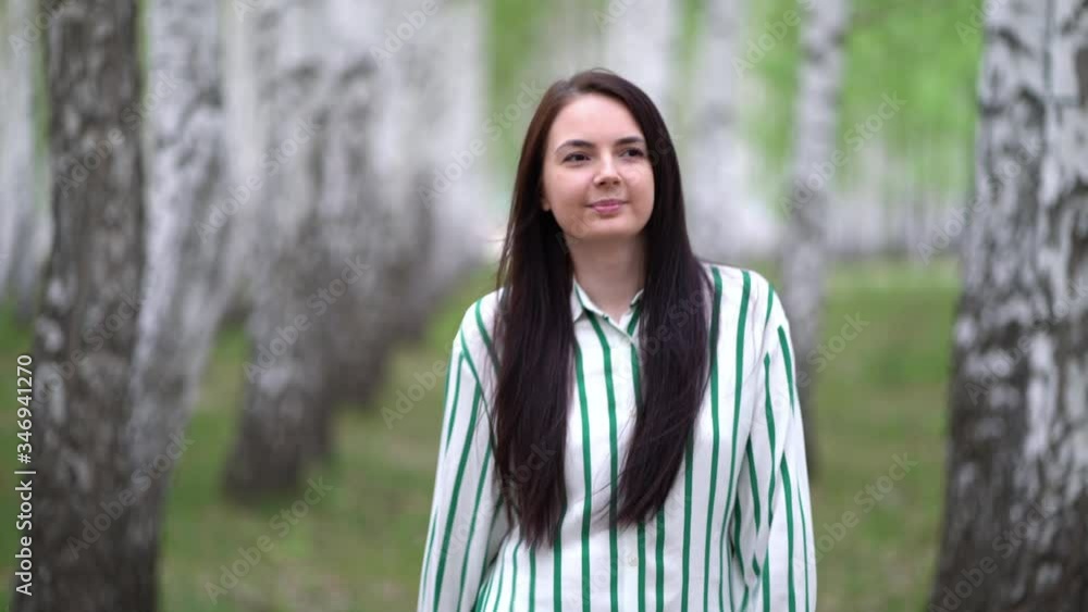 Girl walks in a birch grove on a spring day. Birch tree alley landscape. Girl walks in a birch grove on a spring day. Birch tree alley landscape.