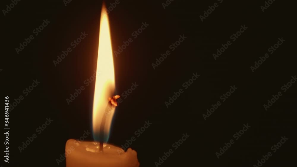 Close up view on candlle burning in darkness. High steady flame barely moves above the paraffin. Close up view on candlle burning in darkness. High steady flame barely moves above the paraffin.