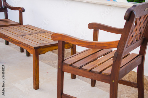 Cozy summer cafe. Wooden tables and chairs on outdoor terrace.