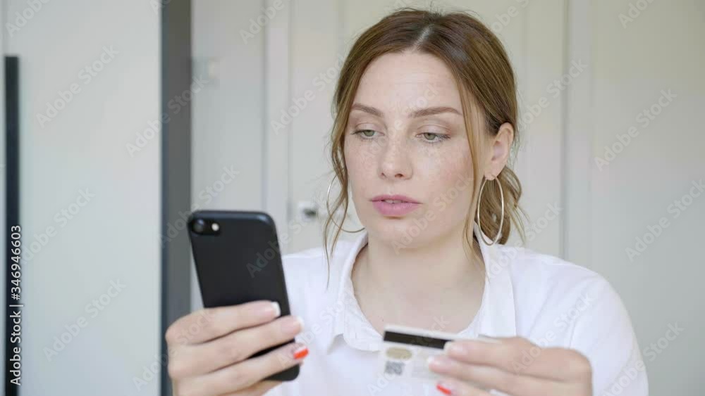 Happy relaxed young woman holding smartphone looking at cellphone screen laughing enjoying using mobile apps for shopping having fun playing games chatting in social media sit on room at home..... Happy relaxed young woman holding smartphone looking at cellphone screen laughing enjoying using mobile apps for shopping having fun playing games chatting in social media sit on room at home.....
