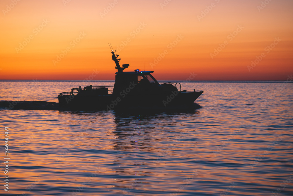 Patrol ship silhouette at the sunset