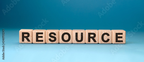 Resource word cube on a blue background. Business concept.