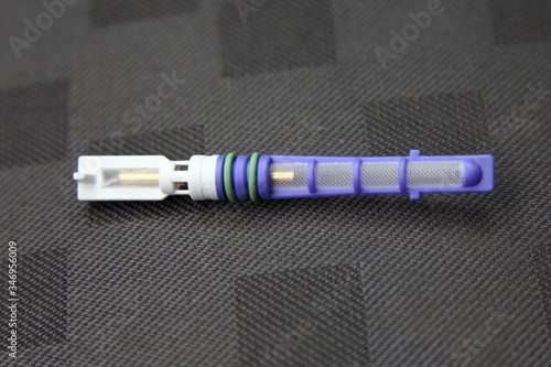 Car conditioner orifice tube valve replaceable freon filter close up, automobile A/C maintenance