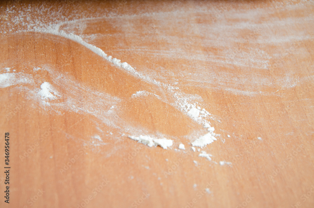 Fototapeta premium Flour on the table. Small lumps of dough on the table. Cocaine like flour