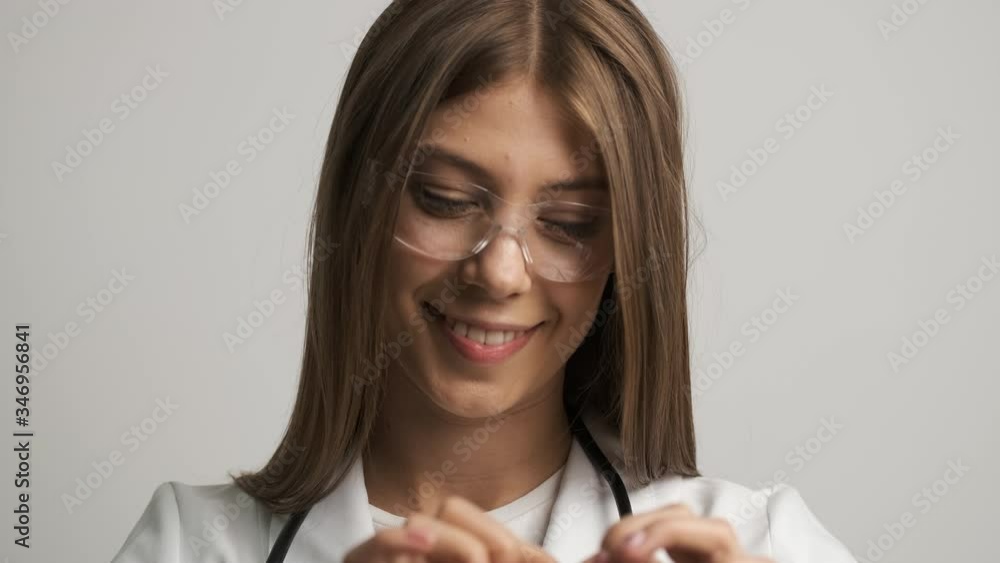 Beautiful women doctor of Caucasian appearance smiles at the camera and holds a stetoscop.Medicine. Health Beautiful women doctor of Caucasian appearance smiles at the camera and holds a stetoscop.Medicine. Health