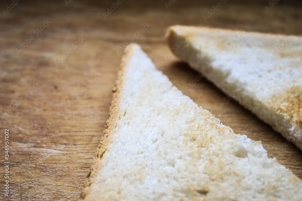 Two pieces of bread on a wooden table