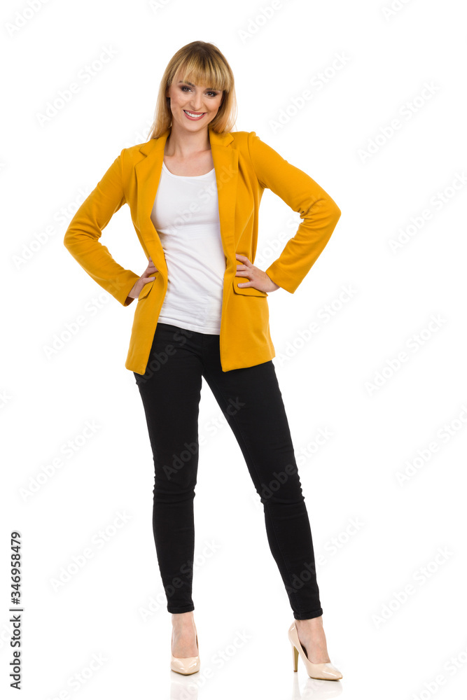 Woman In Yellow Jacket Is Standing With Hands On Hip Woman In Yellow Jacket Is Standing With Hands On Hip