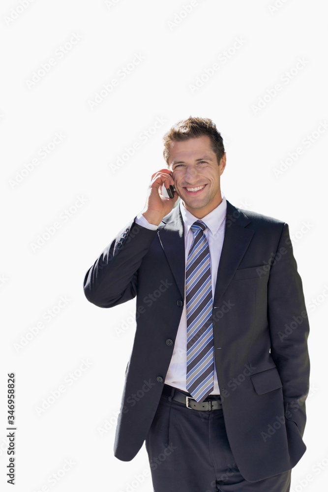Cutout of mature confident businessman smiling and talking on smartphone while walking on pavement Cutout of mature confident businessman smiling and talking on smartphone while walking on pavement