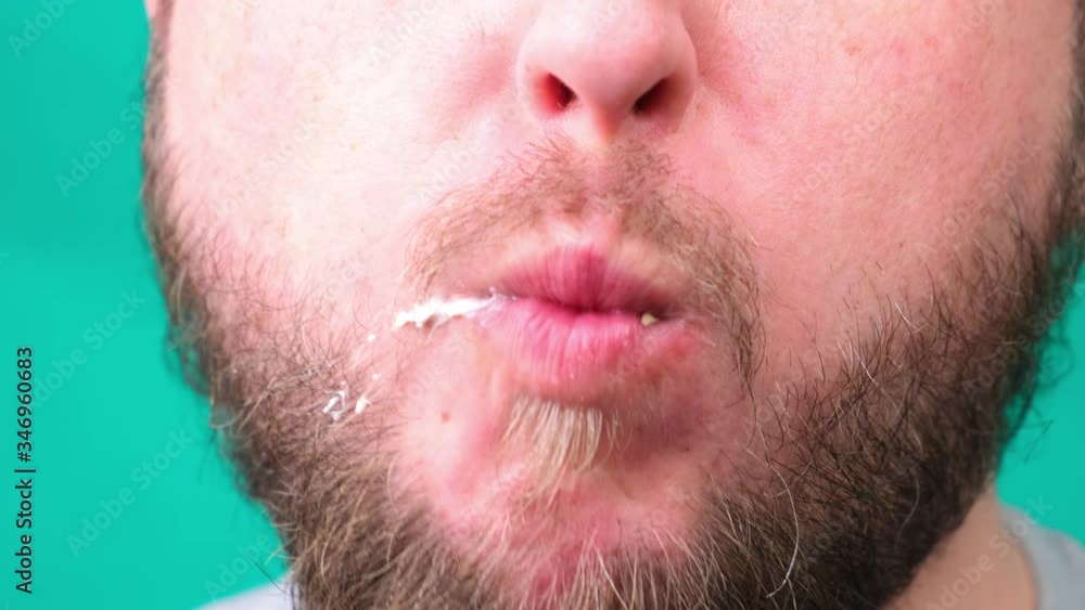 Fat man with beard eats burger closeup Fat man with beard eats burger closeup