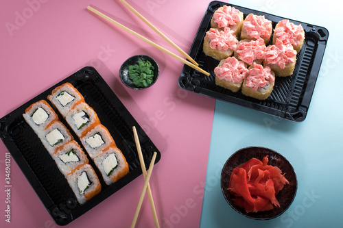 Rolls with pink cream and Philadelphia roll in black plastic box