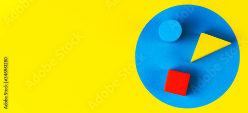 Free Download Wooden colorful blocks on geometric yellow blue background. Natural educational zero waste wood toys. Top view - GFXLoad