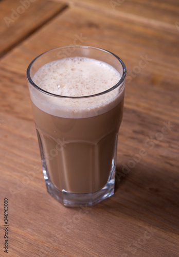 glass of cappuccino on a wooden table