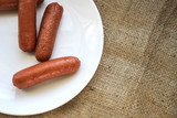 Fried sausages on a white plate