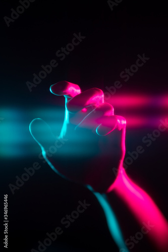 Retro synthwave abstract blue red reaching for viewer hand with lens flaring effects with black background