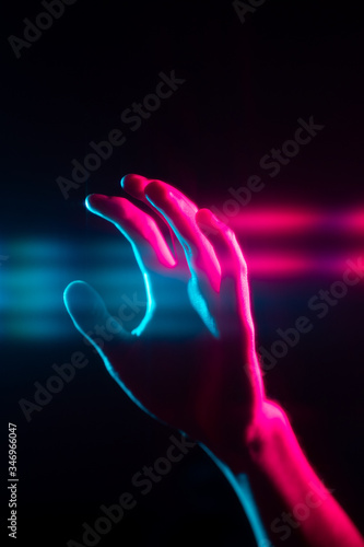 Retro synthwave abstract blue red reaching hand with lens flaring effects with black background