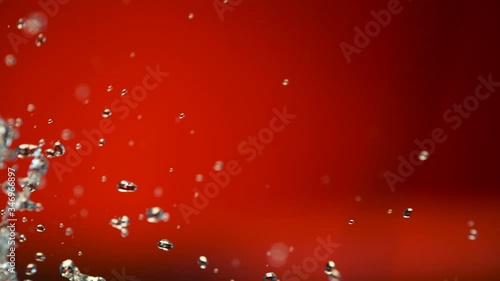 Isolated splash of water with red background. 1000 fps. 
Phantom 4K 