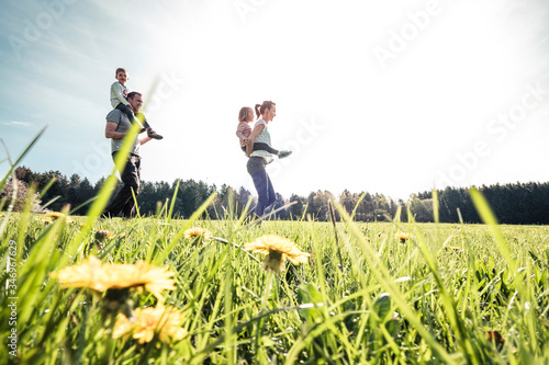 Happy family with two kids on a meadow in spring photo