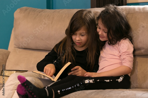 Cute Little Sisters Reading the Holy Bible photo