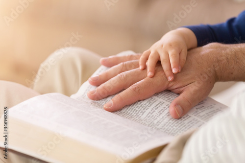 Grandpa Reading to Baby Boy From the Bible