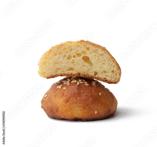 baked round bun with sesame seeds isolated on a white background