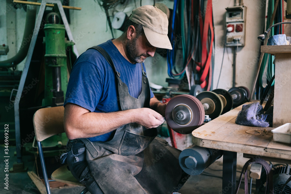 Craftsman making knives in his workshop Craftsman making knives in his workshop