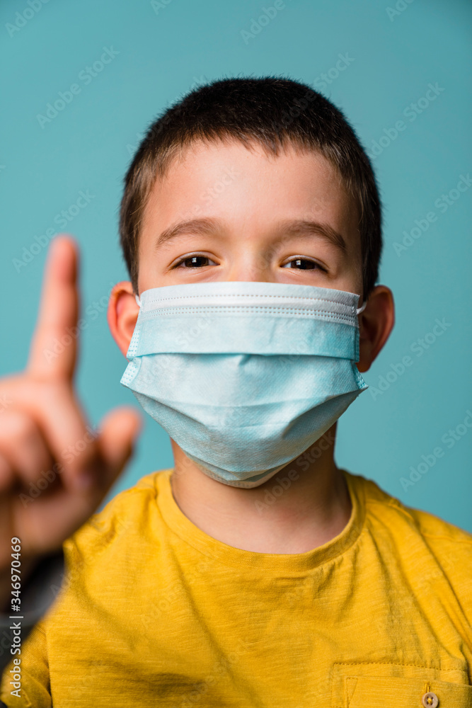 Portrait of boy with mask wagging finger Portrait of boy with mask wagging finger