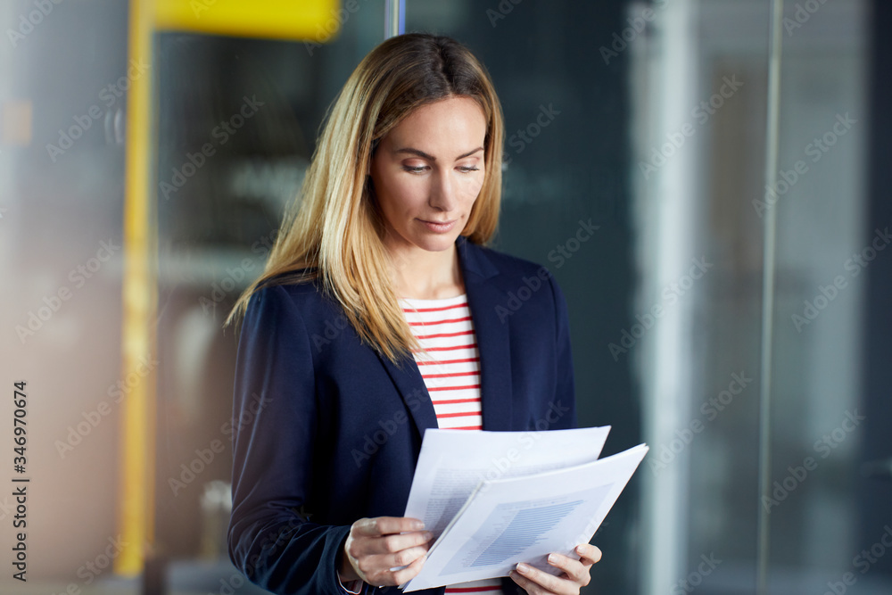 Portait of businesswoman reviewing papers in office Portait of businesswoman reviewing papers in office