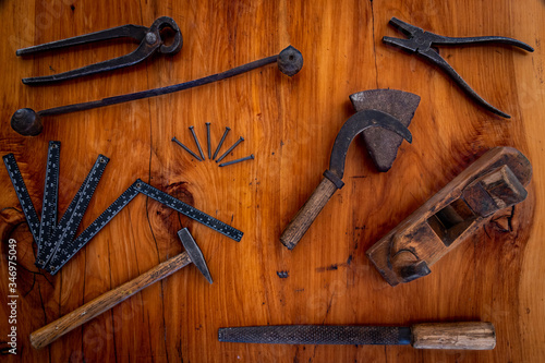 hammer, nails and other tools on wood