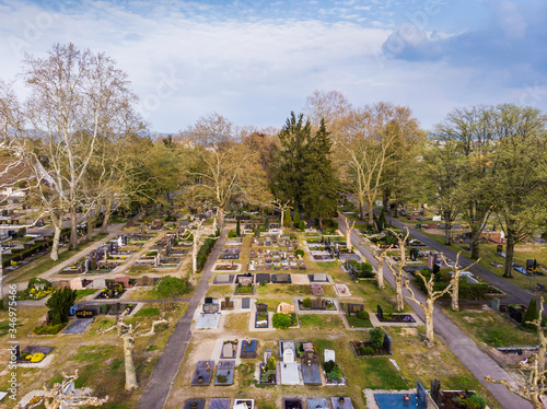 Top view of the city cemetery in Viernheim. Rows of graves. Gray trees. Germany.