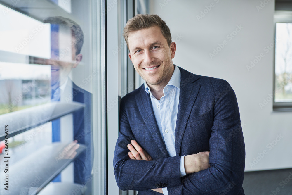Portrait of confident businessman at the window