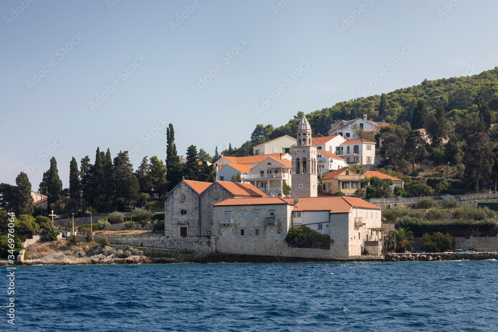 Korcula island with a Dominican Monastery, view from the sea on a sunny day in the summer blue sky. Clear adriactic sea, the south mediterranean coast of Croatia Europe. Beautiful landscape