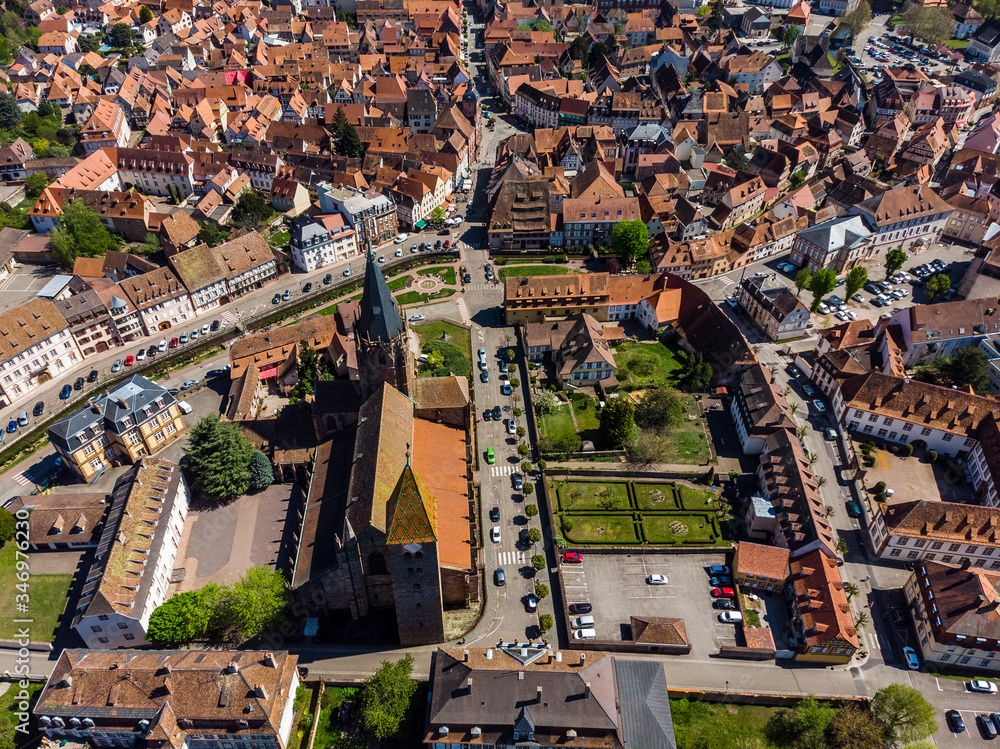 Beautiful top view of the French city of Wissembourg. Old catholic cathedral. Orange tiled roofs. Old city. Parks, squares, streets from above.