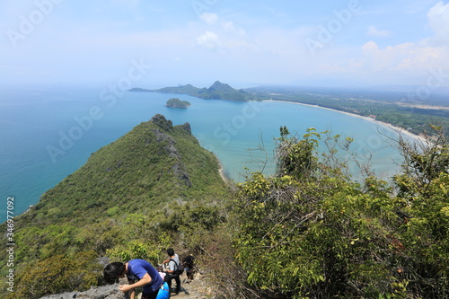 Tourism or hiker climbing mountain on island, adventure mountain climbing lifestyle, Prachuap Khiri Khan, Thailand