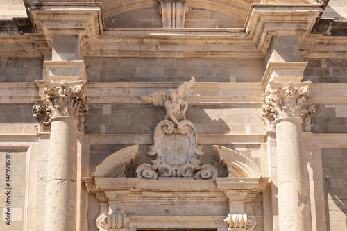 Jesuit church of St. Ignatius in Dubrovnik, Dalmatia, Croatia. Detail of the exterior with an angel on a sunny day and a blue sky. Hirstorical famous travel location on Stradun of the Old Town