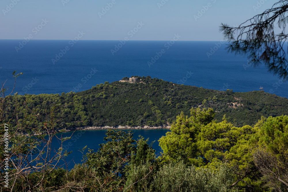 Lokrum Island near the Dubrovnik Old Town on the Adriatic Sea in Croatia seen from above. A green island with a fort on it, shot on a sunny day in summer and a blue sky
