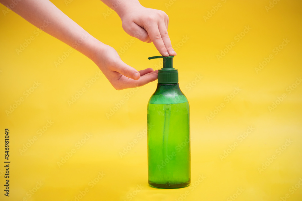 Close-up of hands, a boy applies an antiseptic spray on his hands, demonstrates the rules of hygiene and disinfection of hands with a coronovirus Close-up of hands, a boy applies an antiseptic spray on his hands, demonstrates the rules of hygiene and disinfection of hands with a coronovirus