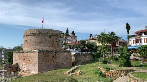 4k video of ancient Hidirlik Tower Castle in Kaleici, Antalya, Turkey. Landscape of Antalya old town and Mediterranean sea. photo