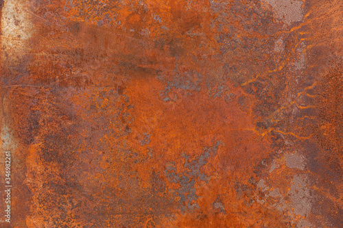 Orange red old rusty metal surface. An weathered oxidized patina with a copper color, texture and structure. Vintage material effect photo